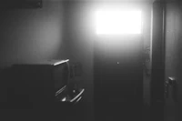 a black and white photo of a room with a tv