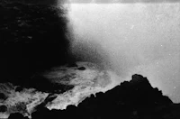 a black and white photo of a waterfall