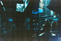 a group of people standing in a crowded market